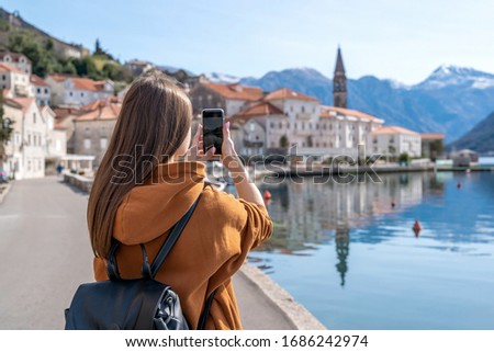 Young Girl Taking Photos Of Landscape With Mobile Smart Phone