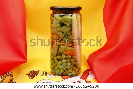 Product from Spain, insulated glass jar with mixed vegetables of the garden, cooked, keeping all their properties, on the flag of Spain, product photo, natural medicine,