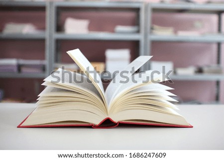 Open Book on the Table in the Bookstore