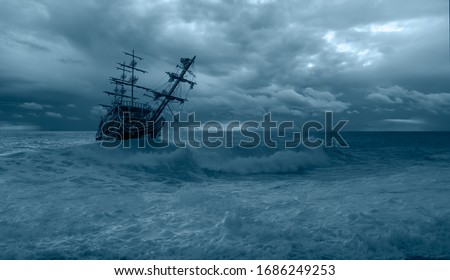 Sailing old ship in a storm sea in the background stormy clouds Royalty-Free Stock Photo #1686249253