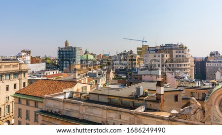 View on roofs with a green top of dome of the Basilica San Carlo al Corso of Milan