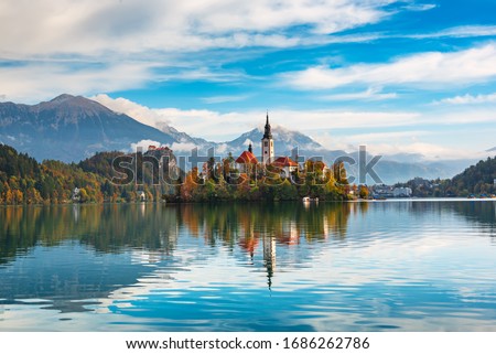 Church of Assumption in Lake Bled, Slovenia with blue sky and clouds in the autumn Royalty-Free Stock Photo #1686262786