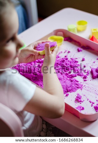 Girl preschooler sculpts kinesthetic sand at home. Developing activities for children. Art therapy. Psychological therapy for children. Quarantine classes for children.