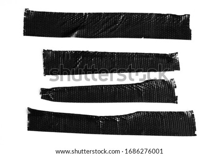 Set of black tapes on white background. Torn horizontal and different size sticky tape, adhesive pieces. Royalty-Free Stock Photo #1686276001