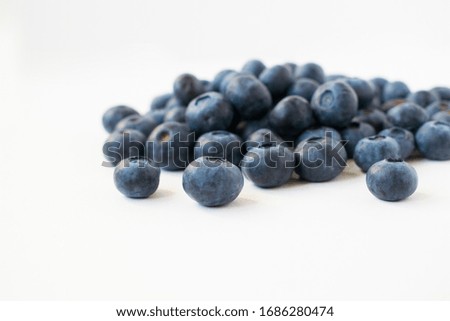 A handful of blueberries. Isolated on grey background. 