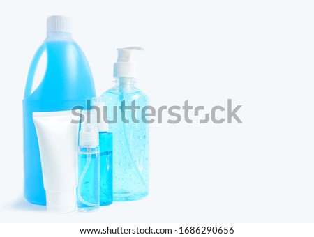 Hand sanitizer gel pump dispenser, white plastic tube, alcohol spray and a gallon of blue alcohol on white background for hand hygiene and Coronavirus or covid19 prevention Royalty-Free Stock Photo #1686290656