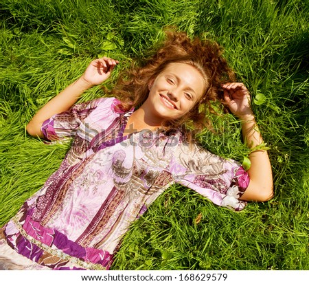 portrait of young smiling woman on the grass 