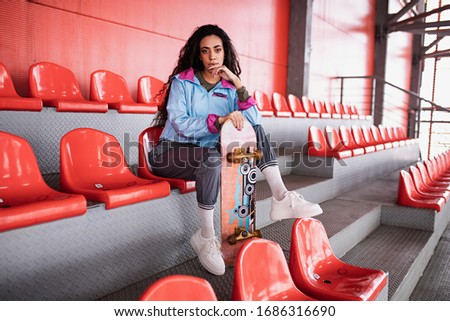 beautiful curly black girl with long hair in the stadium