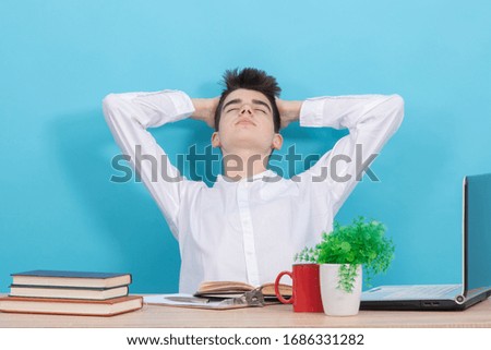 student with relaxation expression sitting at the desk