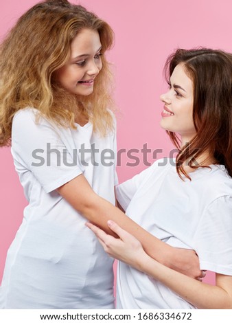 Pink background of a woman and little daughter