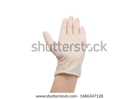 Woman puts on white rubber gloves. Isolated on white.