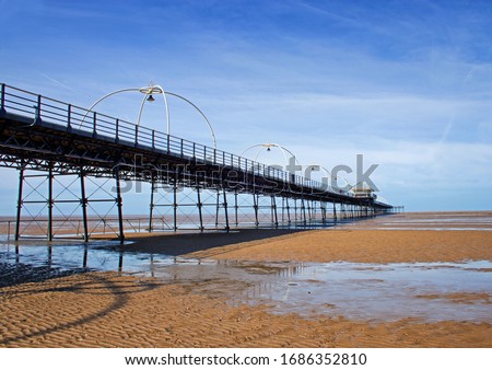 Southport Pier, viewed from the beach with patterns of residual water in the foreground Royalty-Free Stock Photo #1686352810