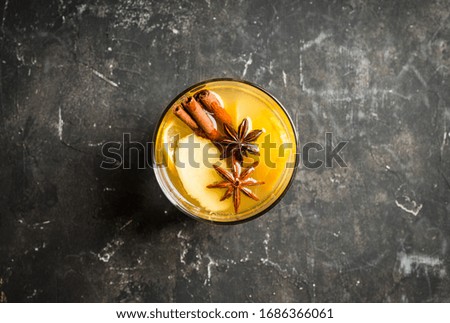 Healthy hot beverage with lemon, ginger and spices for protection in flu season. Selective focus. Shallow depth of field.
