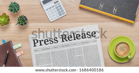 A newspaper on a desk with the headline Press Release Royalty-Free Stock Photo #1686400186