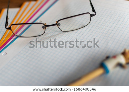 close-up of a glasses on folios on a table