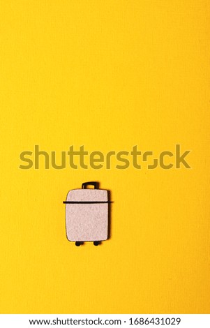 wooden suitcase on the yellow background