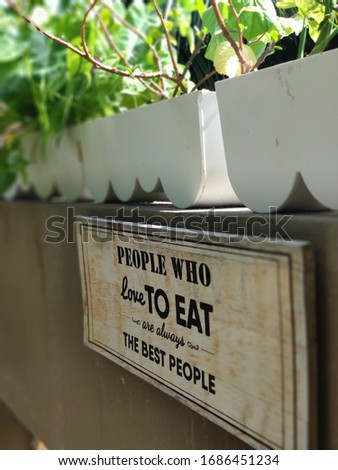 Wood signs lettering wall hanging with quote: "People, who love to eat are always the best people"