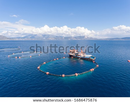Drone photo of a fishing boat in an open sea fish farm in Aegean Turkey Royalty-Free Stock Photo #1686475876
