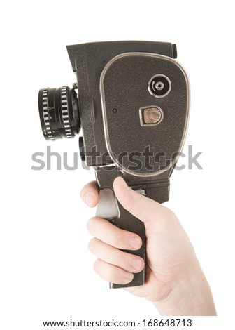 Man Hand holding small video old retro black camera  8 mm isolated on white background 