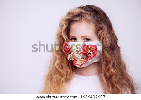 A girl with a respirator. The mask is decorated with flowers. Royalty-Free Stock Photo #1686492697