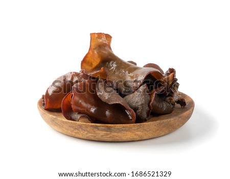 Wet black fungus, tree ear or wood ear mushroom isolated on white background side view. Soaked dry auricularia polytricha also known as cloud ear, black mushroom, jelly fungus or cloud ear fungus Royalty-Free Stock Photo #1686521329