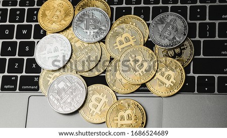 Groups of bitcoin is place on the keyboard of the laptop. Online payment technology, digital wallet, computer financial,  cryptocurrency trading and investment concept.
