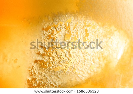 Bee honey. The texture of honey in the jar. Yellow flower honey in the sun.