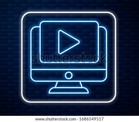 Glowing neon line Online play video icon isolated on brick wall background. Computer monitor and film strip with play sign.  Vector Illustration