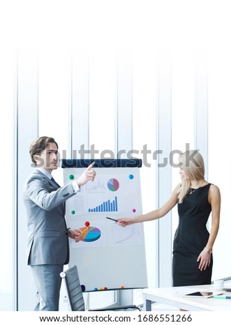 Businessman making financial presentation on flipchart at business meeting