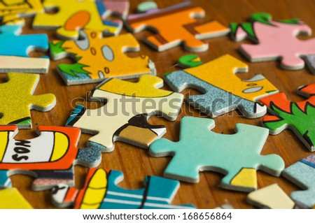 Children's puzzle scattered on a wooden table