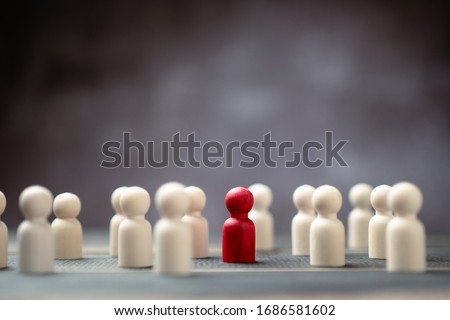 Wooden figure standing with team to show influence and empowerment. Concept of business leadership for leader team, successful competition winner and Leader with influence Royalty-Free Stock Photo #1686581602