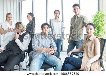Group of initiative multi-ethnic group young business people sitting in creative modern office, business and financial concept.
