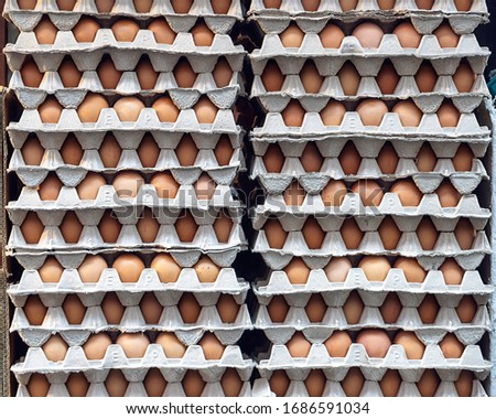 Rows of stack of egg trays.  Storage of a large stock of chicken eggs. 