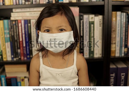 Young Asian girl wearing medical mask