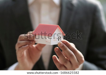 Close up of businessman holding model house. Architecture, building, construction, real estate and property concept 
 Royalty-Free Stock Photo #1686625582