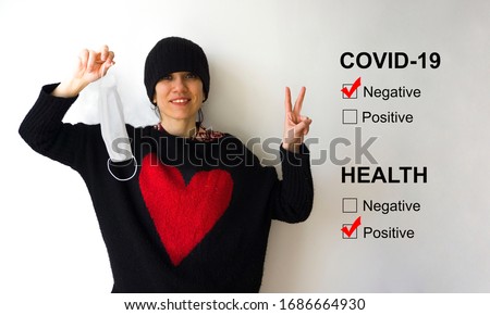 Young beaufitul woman removing her mask because she beat Corona virus, isolated on white background. She won illness war, happiness concept. Female making / showing victory v-sign.