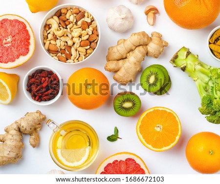 Food for immunity stimulation and viruses protection. Broccoli, citrus fruits, honey, ginger, lemon, garlic, goji, turmeric on white background. Set of different healthy food to boost immune system Royalty-Free Stock Photo #1686672103
