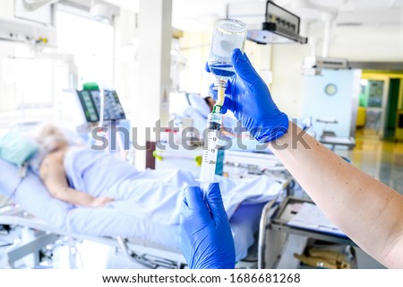 Nurse is preparing intravenous medication in intensive care unit. Royalty-Free Stock Photo #1686681268