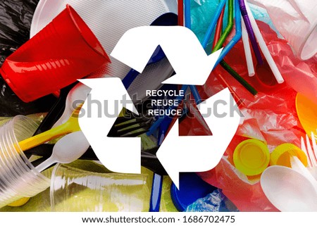 Waste reuse concept. Various plastic garbage and recycling emblem, top view. Collage