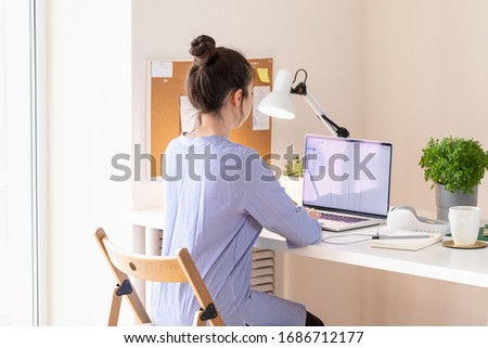 Woman using laptop, workplace in modern style. Communication and telecommuting. Social distance
