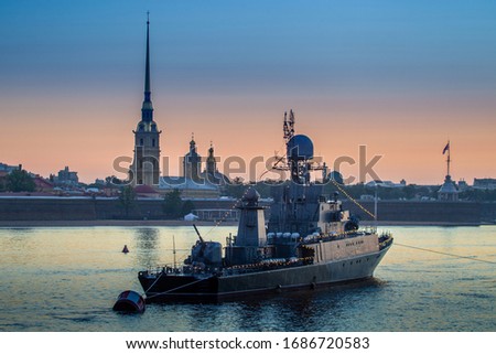 Saint Petersburg. Russia. Ship on the Neva. Rivers Of St. Petersburg. White night. Warship on the background of the Peter and Paul fortress. The vessel on the Neva is decorated with garlands.