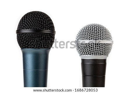 Pair of simple vocal microphones, mic grills closeup shot, objects isolated on white, cut out. Singing, recording voice studio equipment abstract concept. Two kinds of dynamic mics, top part up close