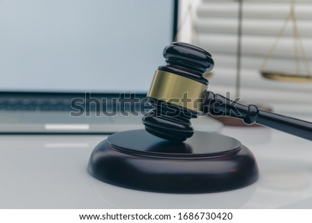 Workspace of lawyer with laptop blank white screen and law wooden gavel,legal book and brass scale of judge. lawyer and law ,judiciary and legislature courtroom legal concept.
