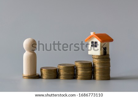 Property investment and house mortgage financial concept. saving money to invest in a home or property in the future. On a gray background