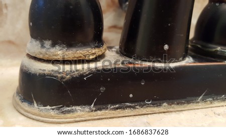 Base of Wrought Iron Faucet with Hard Water Stains and Mineral Buildup Royalty-Free Stock Photo #1686837628