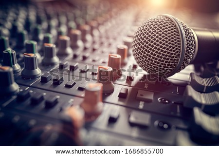 Recording studio mixing desk with microphone on mixer control desk Royalty-Free Stock Photo #1686855700
