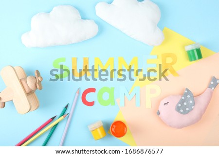 The inscription "summer camp" on a colored background top view.
