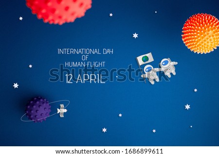 International day of human space flight. 12 April World Cosmonautics Day. Astronaut explores space on a blue isolated background. The concept of distant galaxies and deep space.