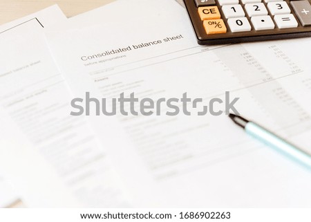 Accounting documents and a calculator on the desktop. Financial concept