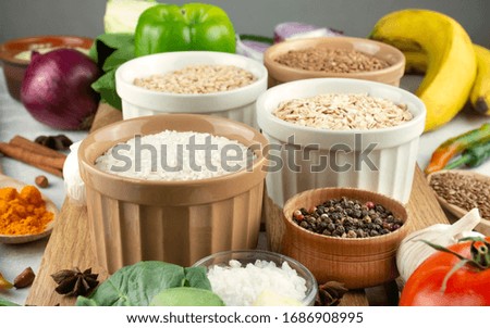 Rice in a bowl closeup in the background various cereals and vegetables. Healthy eating Great food. Vegetarian food. Culinary background for recipes. Food background.